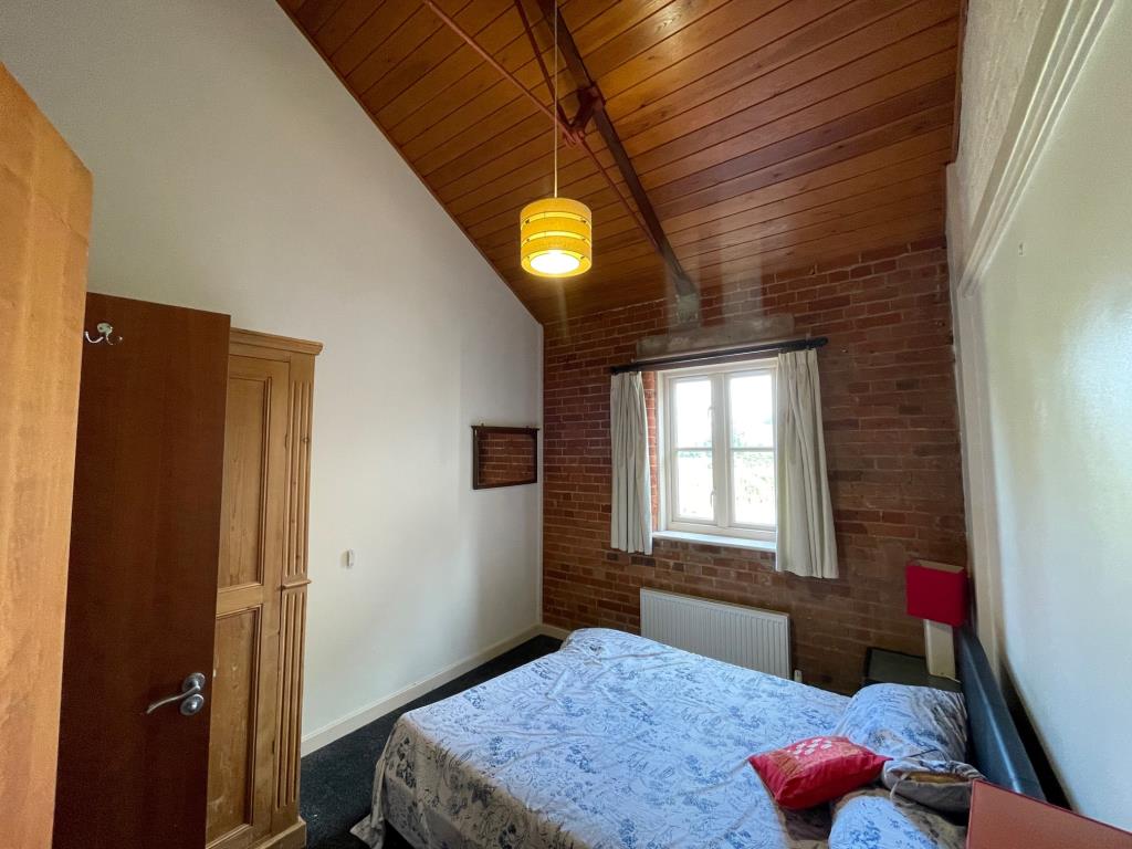 Lot: 160 - THREE-BEDROOM DUPLEX PROPERTY IN CONVERTED MILL COMPLEX - bedroom 2 with door opening to bathroom
